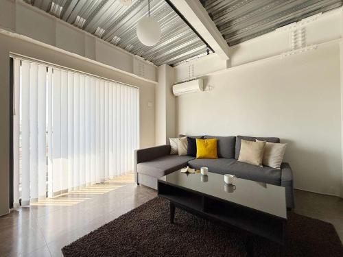 a living room with a couch and a coffee table at b hotel Komachi - 1 BR Apartment Free Breakfast Included in Hiroshima