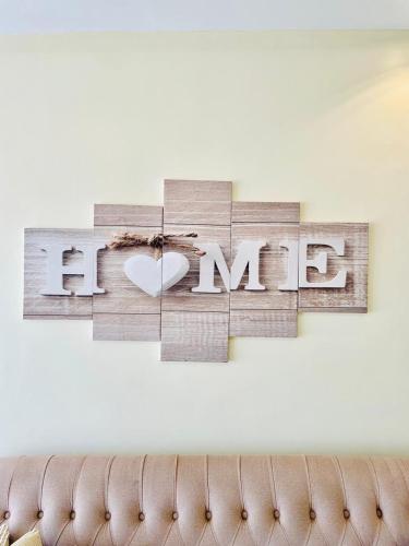 a sign with the word love hanging on a wall at Silverstone Apartments Nairobi, Kilimani in Nairobi