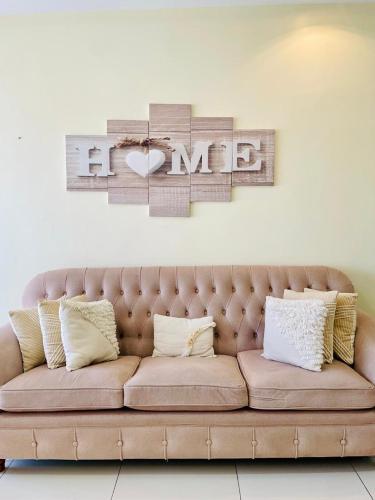 a living room with a couch and a sign that reads me at Silverstone Apartments Nairobi, Kilimani in Nairobi