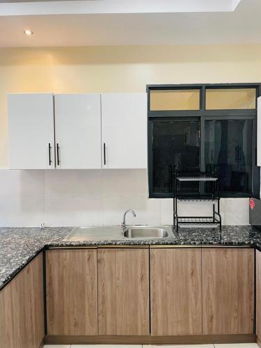 a kitchen with a sink and a counter top at Silverstone Apartments Nairobi, Kilimani in Nairobi
