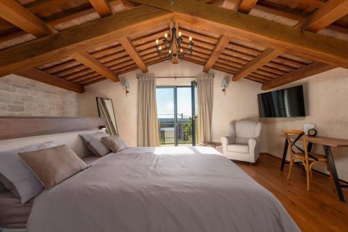 a large bedroom with a large bed and a tv at Villa Paladnjaki - breakfast included in Žminj