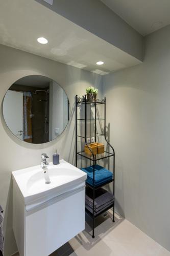 a bathroom with a sink and a mirror at Acco Luxury Apartments in Akureyri
