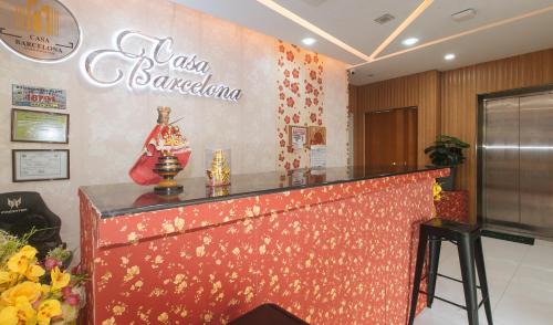 a bar in a restaurant with a sign on the wall at RedDoorz at Casa Barcelona Condotel in Iloilo City