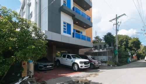 a white truck parked in front of a building at RedDoorz at Casa Barcelona Condotel in Iloilo City