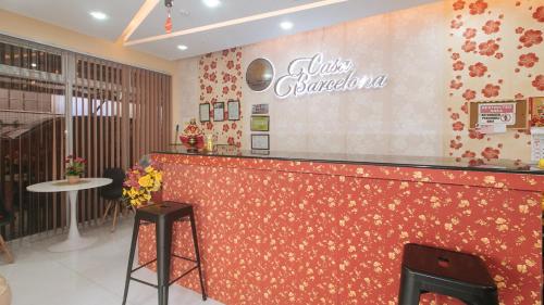 a restaurant with a red counter with a sign on the wall at RedDoorz at Casa Barcelona Condotel in Iloilo City