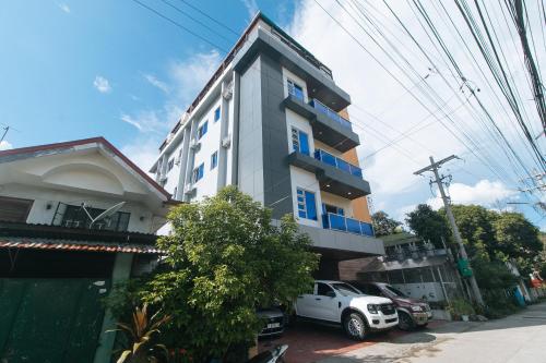 a white truck parked in front of a building at RedDoorz at Casa Barcelona Condotel in Iloilo City