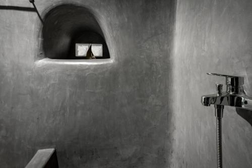 a bathroom with a sink and a mirror on the wall at Lotza Studios in Oia