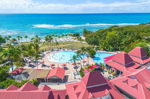 an aerial view of a resort with a pool and the ocean at Village Pierre & Vacances Sainte Anne in Sainte-Anne