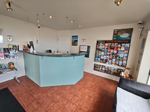 a shop with a blue counter in a room at Great Lake Motel Taupo in Taupo