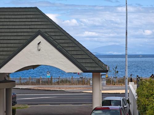 a car parked at a gas station next to the ocean at Great Lake Motel Taupo in Taupo