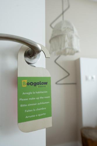 a tag on a door with a sign on it at Boogalow Hostel in Gijón