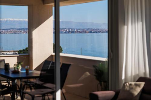 a living room with a view of the water at Vile Dalmacija in Preko