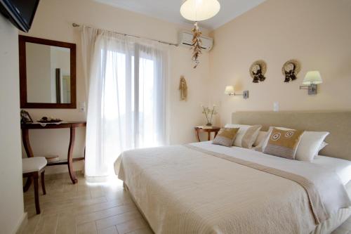 Ένα ή περισσότερα κρεβάτια σε δωμάτιο στο Kores Villas