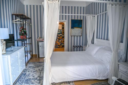 a bedroom with a bed with a canopy at Le residenze del capitano in Bari