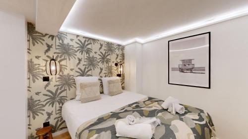 une chambre avec un lit avec un papier peint tropical dans l'établissement 506 Suite Cadet - Superb apartment in Paris, à Paris