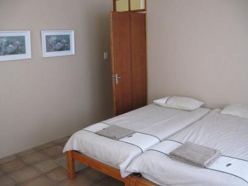 a bedroom with a bed and a wooden door at Guesthouse in the Waterberg in Ouklip