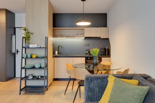 a kitchen and a dining room with a table in a room at Apartmán Galileo in Trnava