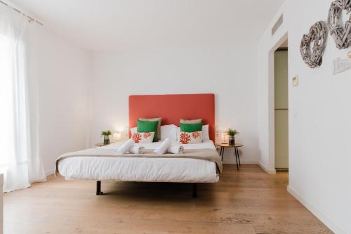 a bedroom with a large bed with green and white pillows at NEW! Villa Boutique Mallorca in Lloseta