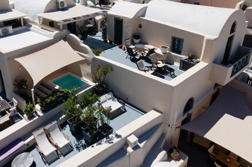 an aerial view of a house with a swimming pool at Lotza Studios in Oia