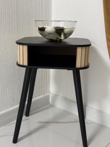 a small black table with a bowl on top of it at A Casa di JO in Bari
