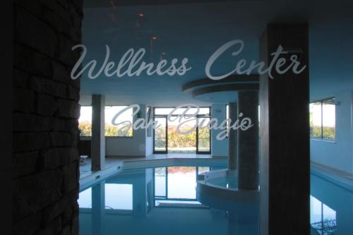 a sign that reads wellness center and a swimming pool at Albergo Ristorante San Biagio in Montepulciano