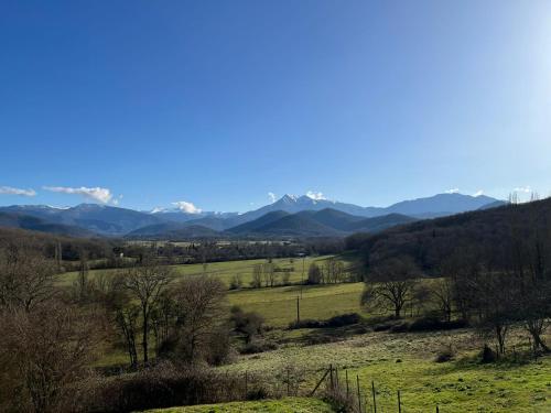 a view of a field with mountains in the background at La Ferme des Hautins - Chambres -d'Hôtes in Rieucazé