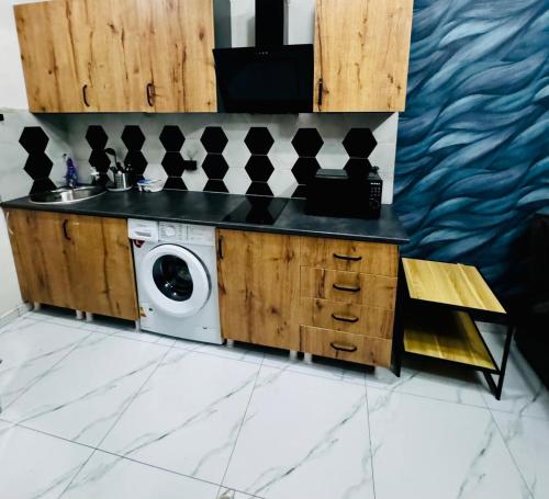a kitchen with a washing machine and a sink at Квартира у Моря in Batumi