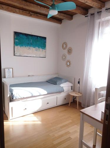 a bedroom with a bed and a ceiling fan at CASAL MICELIO in Udine