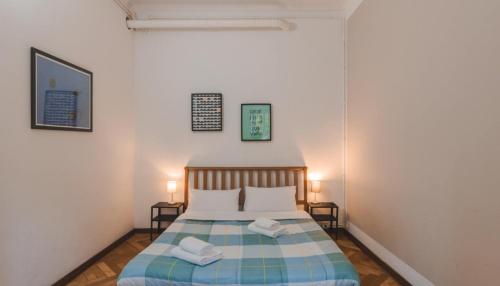 a bedroom with a bed with two pillows on it at Vico 4 Charme Apartments in Trieste