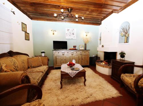 a living room with a couch and a fireplace at Palladio Hotel - Portaria in Portaria
