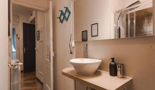 a bathroom with a white bowl sink on a counter at Vico 4 Charme Apartments in Trieste