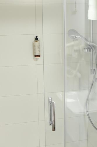 a shower with a bottle of soap on a glass door at Casa BACCO in Rotenburg an der Fulda