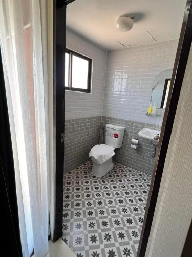 a bathroom with a toilet and a sink at Goodview residence in Sathani Nakhon Lampang
