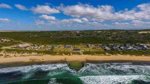 an aerial view of a beach with condos at Africa Unwined Beach house in Witsand