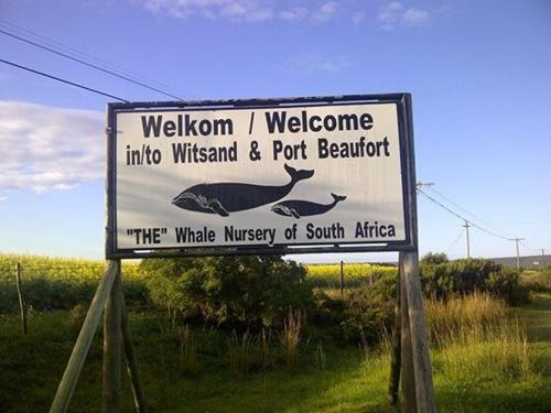 a sign for a welcome to the whale museum of south africa at Africa Unwined Beach house in Witsand