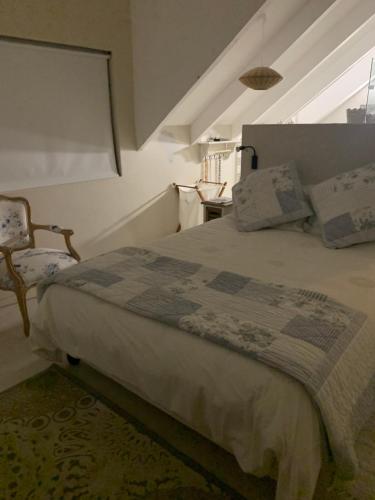 a bedroom with a bed in a room with an attic at Africa Unwined Beach house in Witsand