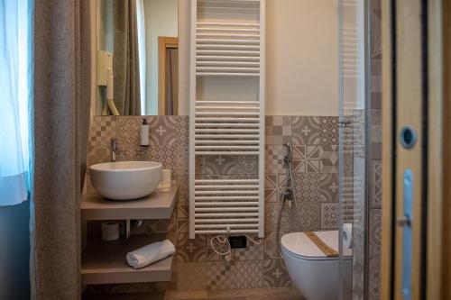 a bathroom with a sink and a toilet at Ile Hotel in Peschiera del Garda
