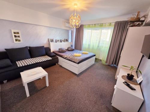 a living room with a couch and a table at Marcos Apartments - self check-in in Reşiţa
