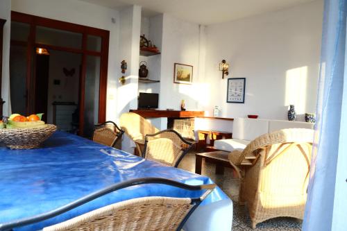 a dining room with a blue table and chairs at Ammiraglio in Campese