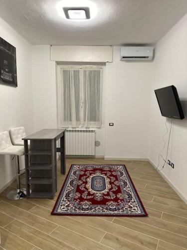 a room with a table and a rug on the floor at Wayhome apartment in Milan in Milan
