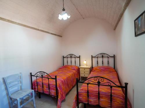 two beds sitting next to each other in a bedroom at Trullo Mont Bell con giardino e piscina privata in Selva di Fasano