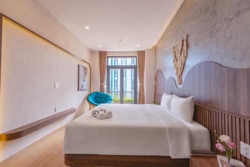 a bedroom with a large bed and a large window at Bullani Hotel & Apartment in Da Nang