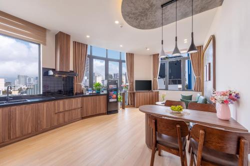 a kitchen and dining room with a table and chairs at Bullani Hotel & Apartment in Da Nang