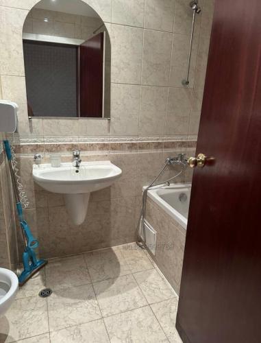 a bathroom with a sink and a mirror and a tub at Miramar Apartment in Sunny Beach