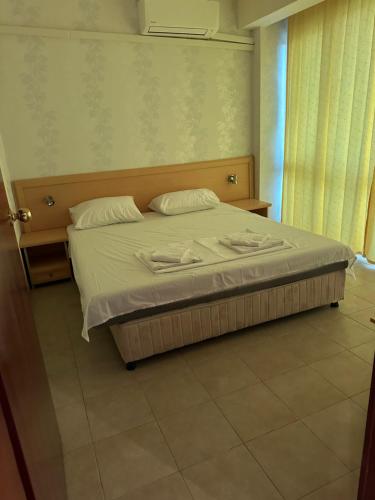 a bedroom with a bed with white sheets and pillows at Miramar Apartment in Sunny Beach