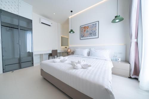Ένα ή περισσότερα κρεβάτια σε δωμάτιο στο Pattaya Interstellar Village Resort House