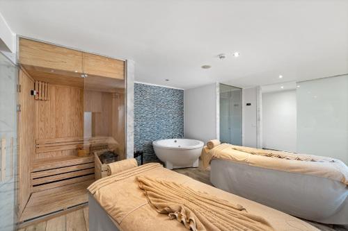 a bathroom with two beds and a bath tub at Steigenberger Aqua Magic, All inclusive in Hurghada