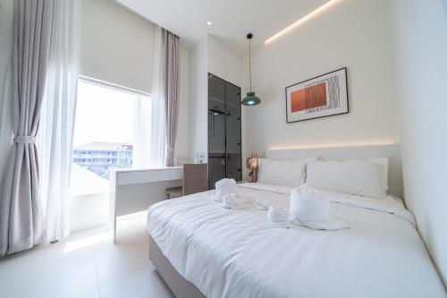 Ένα ή περισσότερα κρεβάτια σε δωμάτιο στο Pattaya Interstellar Village Resort House