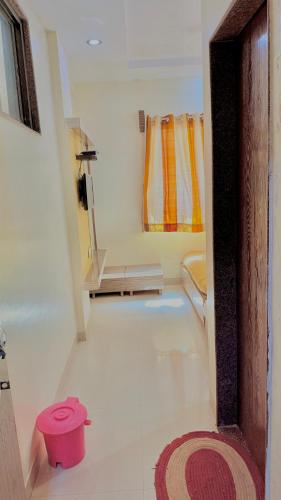 a room with a bathroom with a toilet and a rug at HOTEL GRKK - Near Shri Saibaba Samadhi Temple Shirdi in Shirdi