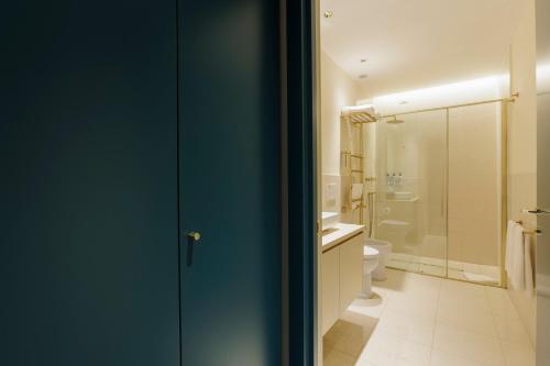 a bathroom with a toilet and a glass shower at Sentho Roma in Rome